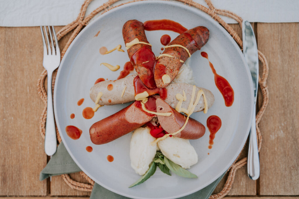 Sausages on a plate with mash potato and sauerkraut